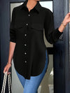 Svart blus med knappar - sofistikerad kvinnotop med sidospalt