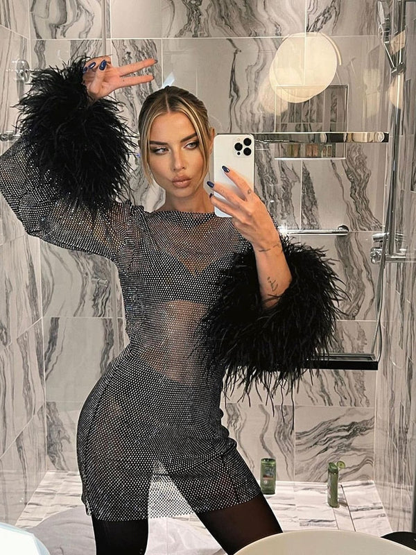 Kvinnlig paljettklänning med fjäderdetaillering - sofistikerad kvällsoutfit